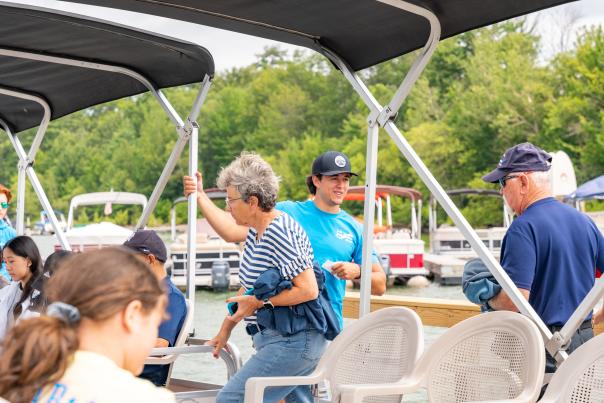 A group of visitors boards a vessel for a trip with Wallenpaupack Scenic Boat Tours.