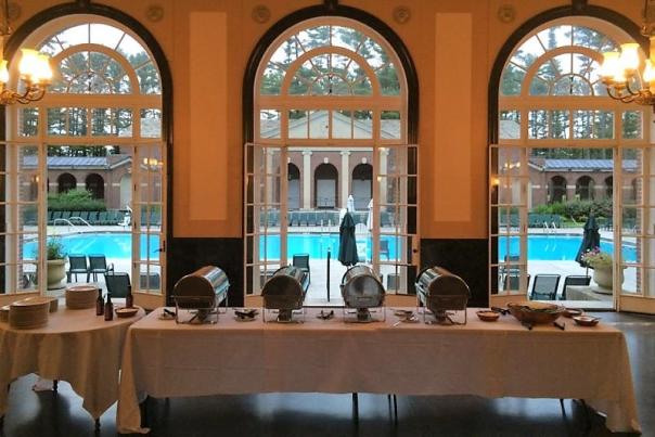 Buffet table set up in front of large windows overlooking Victoria pool