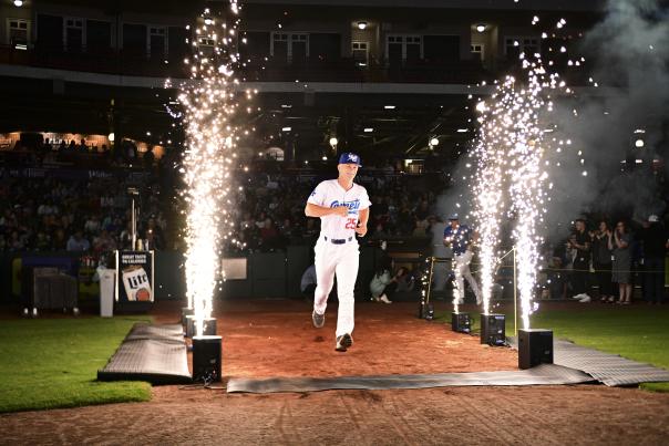 OKC Comets player running through fireworks on the field