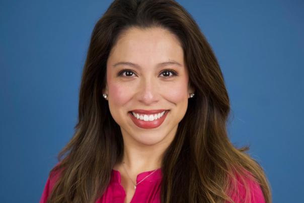woman with brown hair and pink blouse
