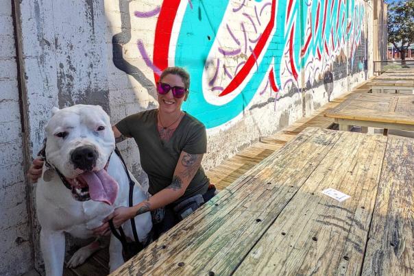 a lady and her dog on the patio at The Sleepy Whale