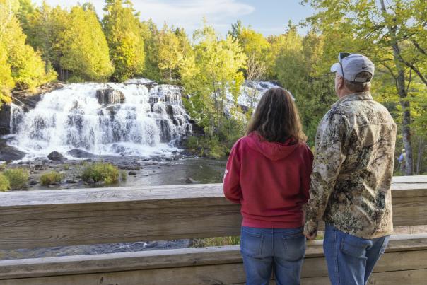 A couple looking out at Bond Falls, located in the Upper Peninsula of Michigan