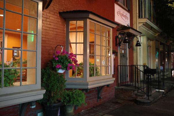 Exterior of a storefront at night on a main street that reads Elizabeth's