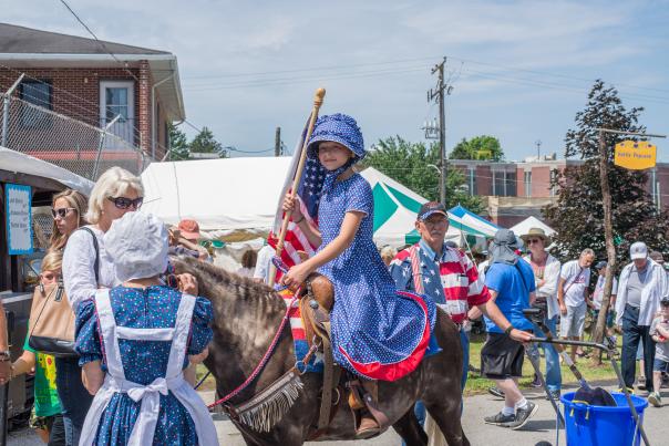 A young girl rides a donkey at the Kutztown Folk Festival