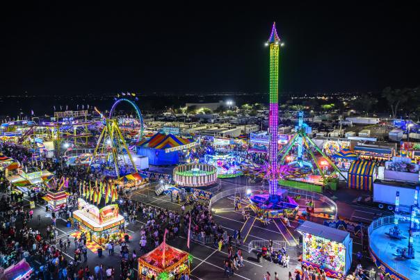 Crowds enjoy rides, food stands, and concerts at the NM State Fair midway at Expo NM in Albuquerque.