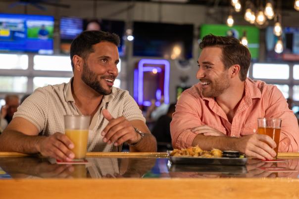 Two guys enjoying a drink at the bar at Twisted Fork in Port Charlotte, Florida