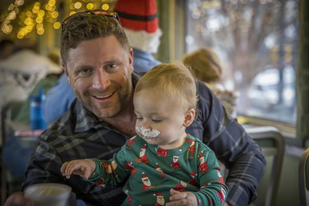 Father and baby in a holiday train car