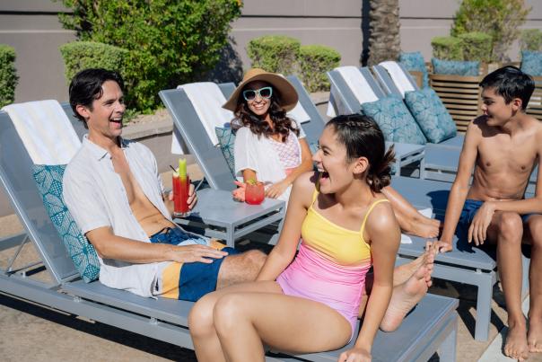 Family sitting by the pool
