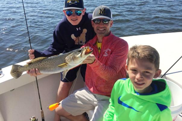 Fun family fishing: showing off a speckled trout caught in Punta Gorda/Englewood Beach