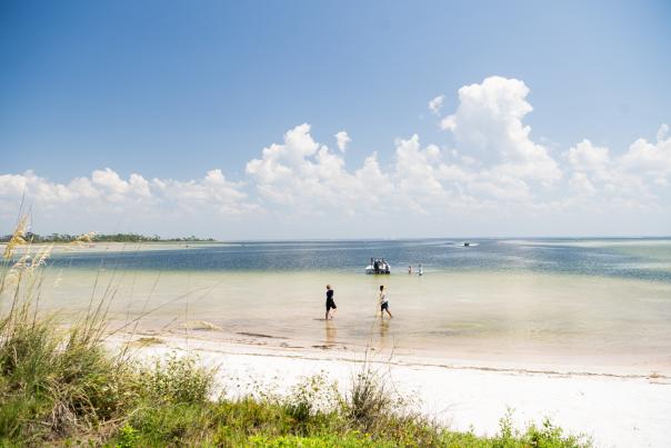 boys running through shallow water at Eagle Harbor, located at T.H. Stone Memorial St. Joseph Peninsula State Park.