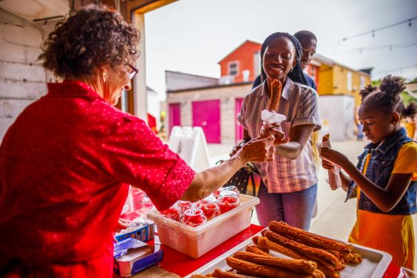 a family buying a churro