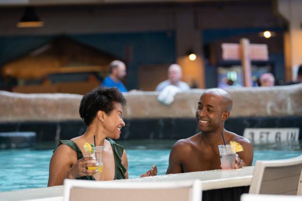 A couple enjoys the swim up bar at Camelback Lodge & Aquatopia Indoor Waterpark in the Poconos.