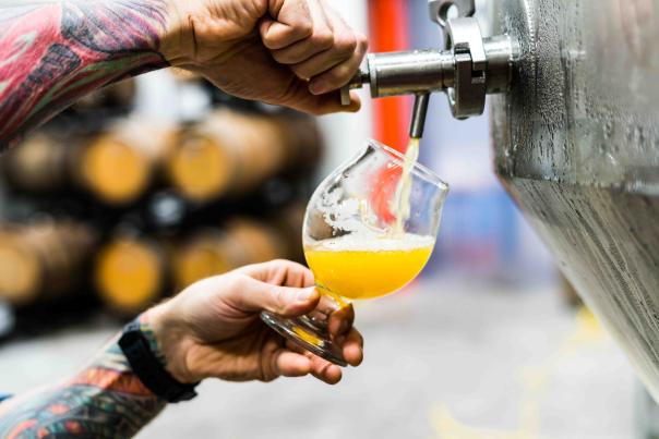 Man pouring a beer out of a tap