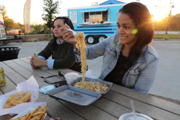 Women eating noodles at The Yard