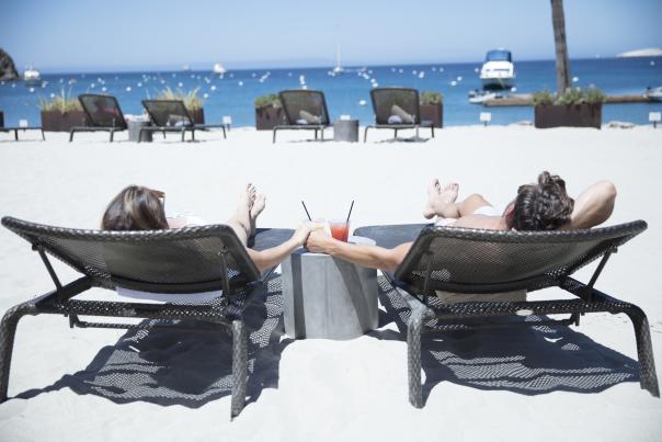 Couple Sunning By The Beach At Harbor Sands On Catalina Island