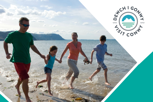 Family running in the sea on a beach