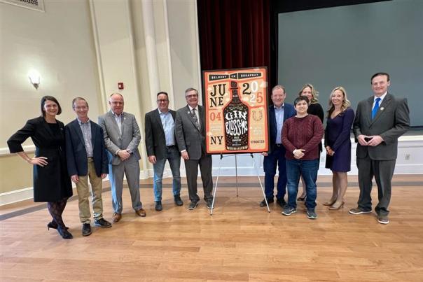local leaders surrounding unveiled poster for summer concert