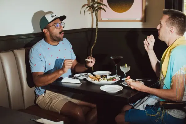 Two people eating at a restaurant.