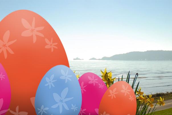 Illustrated Easter eggs overlaid on a photo of Swansea Bay