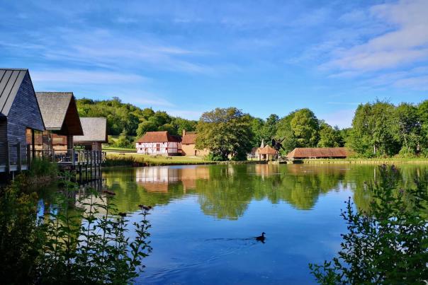 View of the mill pond and cafe buildings on the water at the Weald and Downland museum