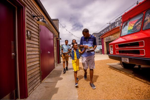 a family walking amongst food trucks