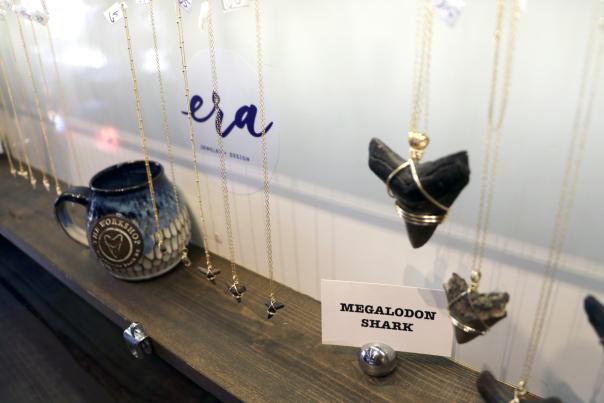 Megalodon necklaces in case at The Workshop in Wrightsville Beach