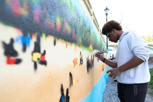 Students help pain the Carr's Beach Mural at MC3