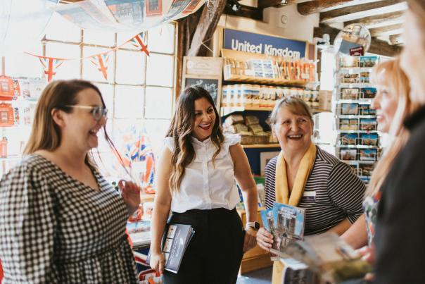 A group of women in conversation, laughing together