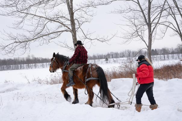 A man rides a horse through the snow during the Tobyhanna Ice Harvest in the Poconos.