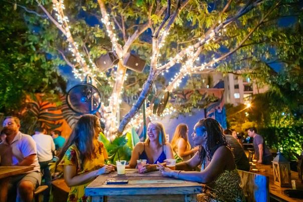 Three ladies enjoying drinks in the outdoor area of Rhythm & Vine