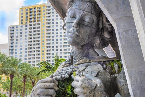 Large statue of woman pulling her chest open