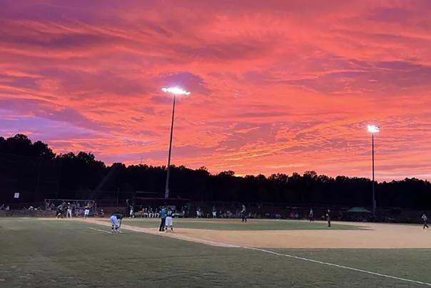 The Clayton Clovers Baseball Team play a home game at sunset
