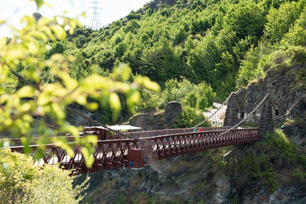 Bikers travelling over the Kawarau Suspension Bridge