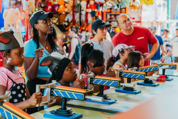 A family enjoying the Carnival games at Main Street Fest in Grapevine, Texas
