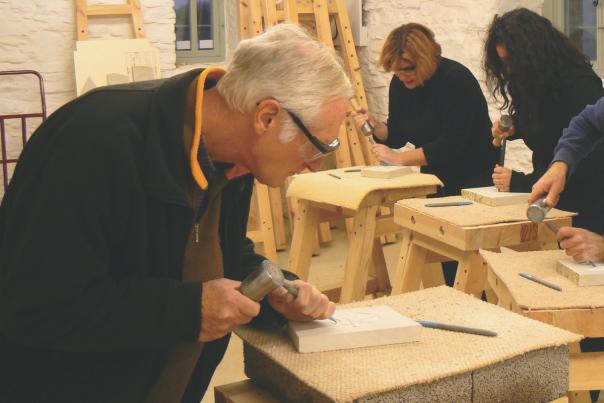 Four people stone carving at Burngate Stone Carving Centre