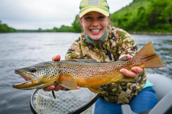 A woman shows off her trout catch in the Poconos