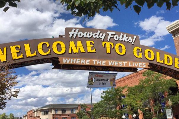 Golden Historic Welcome Arch in Downtown Golden Colorado over Washington Ave. displaying, "Howdy Folks! Welcome to Golden Where the West Lives