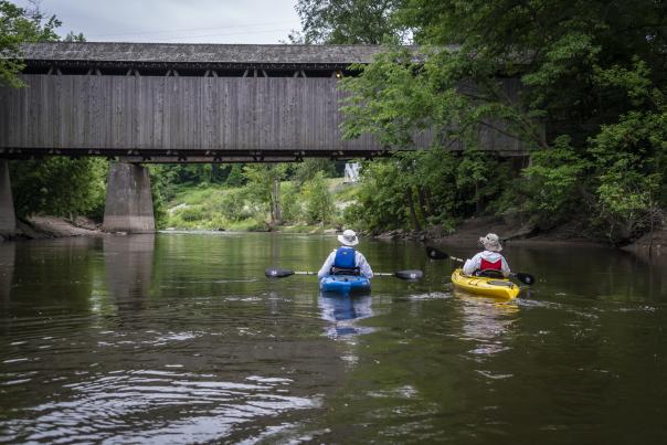 Two people kayaking down the Grand River.