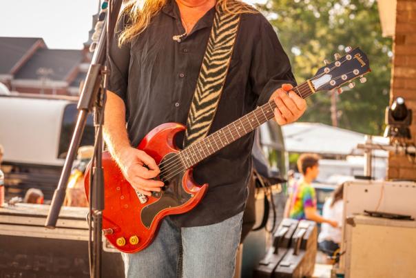 Man playing guitar at the Faith 4th of July Celebration