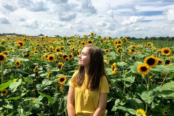 Girl looking up in Sunflower Field at Beasley's Orchard