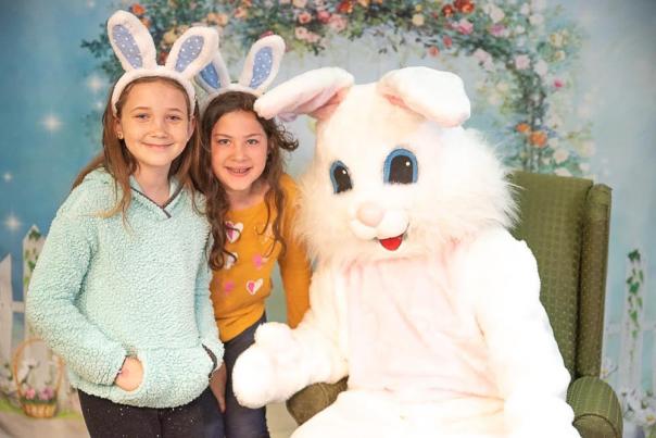 Two girls posing with Easter Bunny
