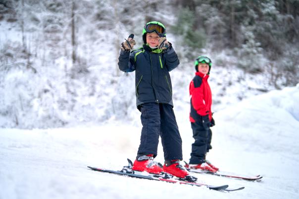 A little boy gives a thumbs up as he prepares for a day of snowboarding at Blue Mountain in the Poconos