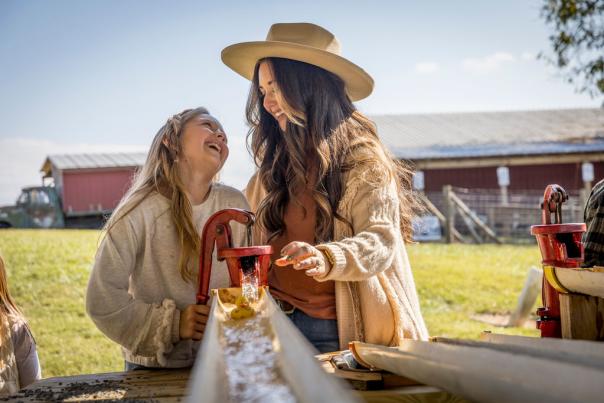 Mom and Daughter playing with water at Patterson Farm
