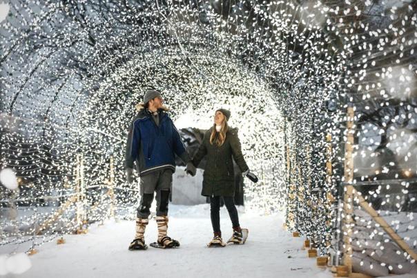 couple walking through twinkling light tunnel