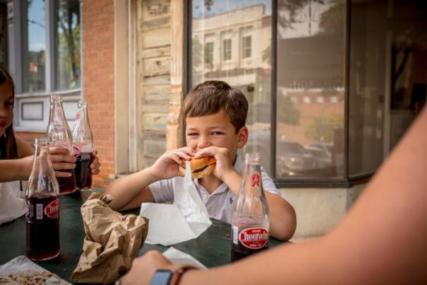 Boy eating burger at Hap's Grill