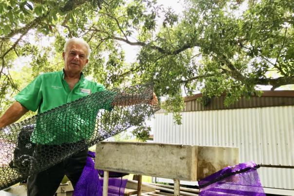 Mayor Sherbin Collette demonstrates his crawfishing equipment outside of his Henderson home.