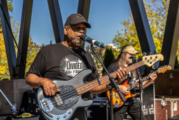 Man playing guitar and singing at Bell Tower Brew Fest