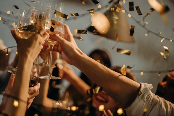 People cheersing champagne glasses at New Years celebration