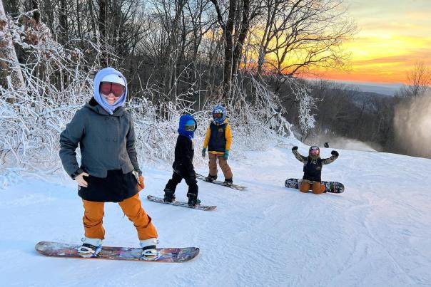 A group of young snowboarders get ready for a run on the slopes in the Pocono Mountains