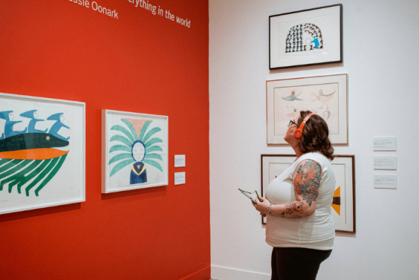 A person viewing different piece of art at the Nanaimo Art Gallery.